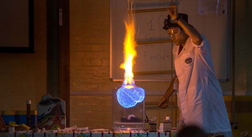 A Mad Scientist making fire in a glass jar