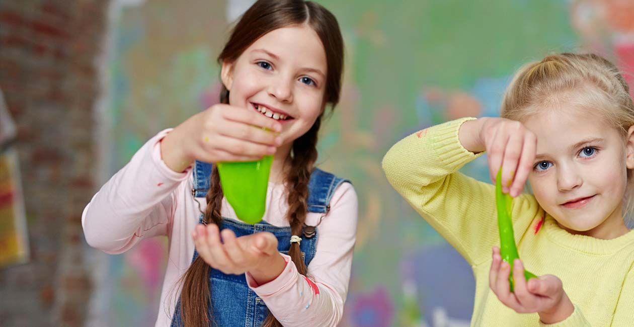 2 girls playing with green slime